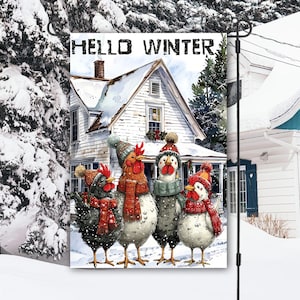 May include: A garden flag with a winter scene. It depicts four chickens in winter attire standing in front of a snow-covered house. The flag has the words "HELLO WINTER" at the top.