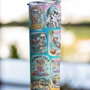May include: A stainless steel tumbler with a colorful design featuring a skeleton in various summer-themed scenes. The tumbler has a straw and the text "Keep Losing Weight for the Summer", "Shaking My Bones at the Beach Party", "Summer Vibes", "Always Salty", "Have the Time of Your Life", "Grillin' No Flesh", and "Splish Splash" is visible on the tumbler.