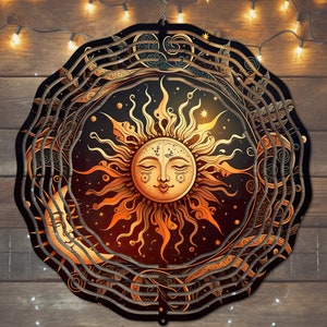 May include: A decorative metal wind chime with a sun and moon design. The sun has a face with closed eyes and a smile. The background is black with gold stars and swirls.