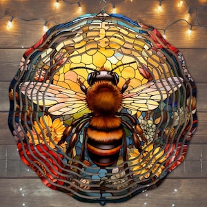 May include: A colorful stained glass wind chime featuring a bee with yellow and black stripes, surrounded by flowers and honeycomb patterns.