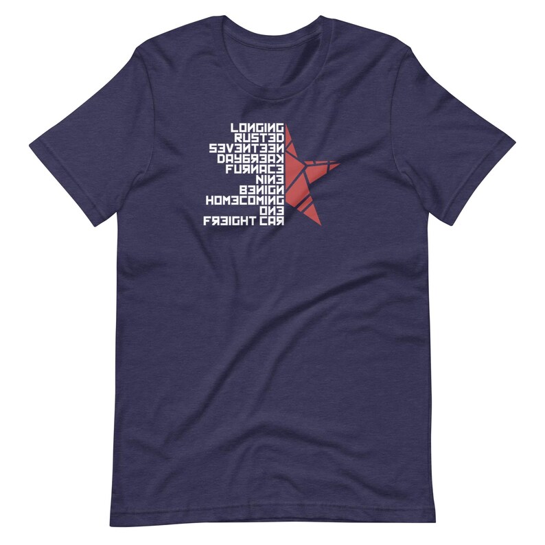 May include: Navy blue t-shirt with white text and a red star graphic. The text includes the words "Longing", "Rusted", "Seventeen", "Daybreak", "Furnace", "Nine", "Benign", "Homecoming", "One", and "Freight Car".