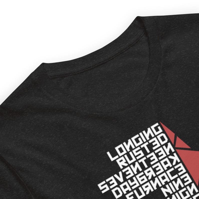 May include: Dark gray t-shirt with white text and a red geometric design. The text includes the words "Longing, Rusted, Seventeen, Daybreak, Furnace, Nine, Benign, Homecoming, One, Freight Car".