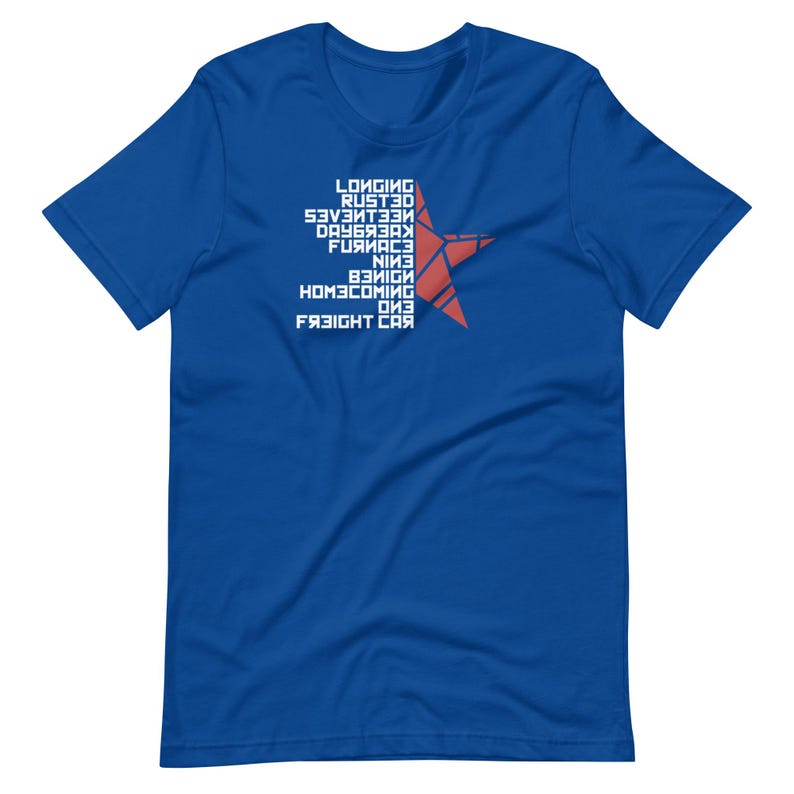 May include: Royal blue t-shirt with white text and a red star design. The text includes words like "Longing", "Rusted", and "Freight Car". The star is made of red lines. A casual tee for everyday wear.