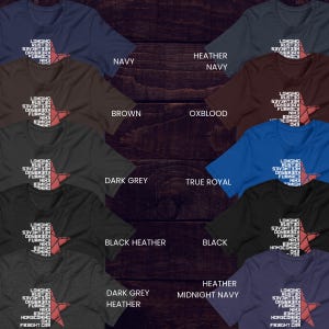 May include: Assorted color t-shirts with a star graphic and the text "LONGING RUST30..." in white. Colors include navy, brown, dark grey, black heather, and heather midnight navy. The shirts are displayed on a dark wood background.