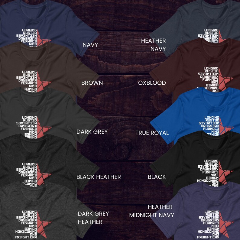 May include: Assorted color t-shirts with a star graphic and the text "LONGING RUST30..." in white. Colors include navy, brown, dark grey, black heather, and heather midnight navy. The shirts are displayed on a dark wood background.