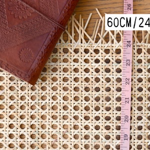 May include: A close-up of a 24-inch (60 cm) wide cane webbing, a natural material used for chair seats and other furniture. The webbing is woven in a diamond pattern and has a natural, light brown colour.