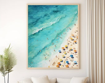 May include: A framed watercolor painting of a beach scene with turquoise water, white sand, and colorful umbrellas. People are swimming and sunbathing on the beach.