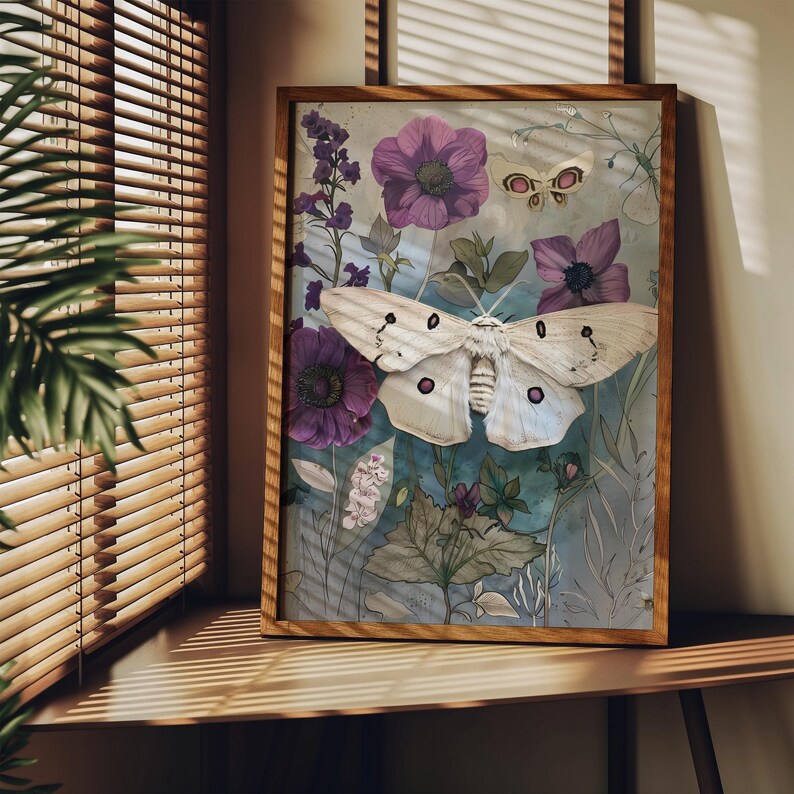 May include: A framed print of a white moth with brown markings, set against a background of watercolor flowers in shades of purple, pink, and green.