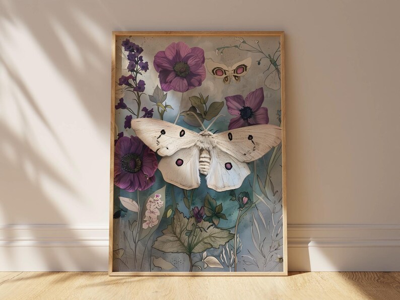 May include: A framed print featuring a white moth with purple accents, surrounded by purple flowers and green foliage on a blue background.