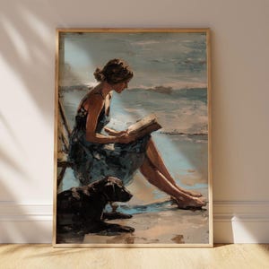 May include: A framed painting showing a person reading on a beach, with a black dog. The artwork uses soft blues and browns to create a tranquil beach scene. The image evokes a sense of leisure and relaxation.