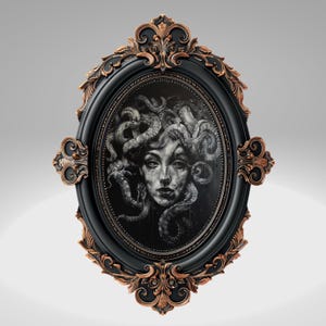May include: A black and gold oval frame with a detailed ornate design. The frame contains a black and white illustration of a woman with snakes for hair.