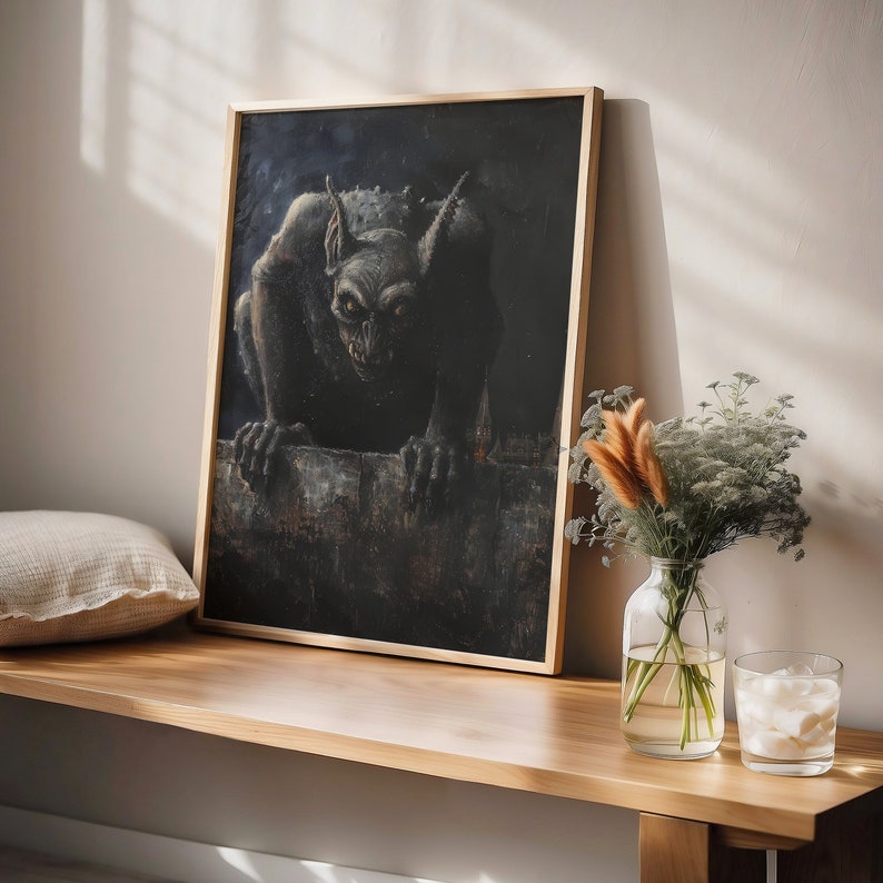 May include: A framed black and white illustration of a gargoyle perched on a ledge. The gargoyle is depicted in a dark, shadowy setting, with a menacing expression.