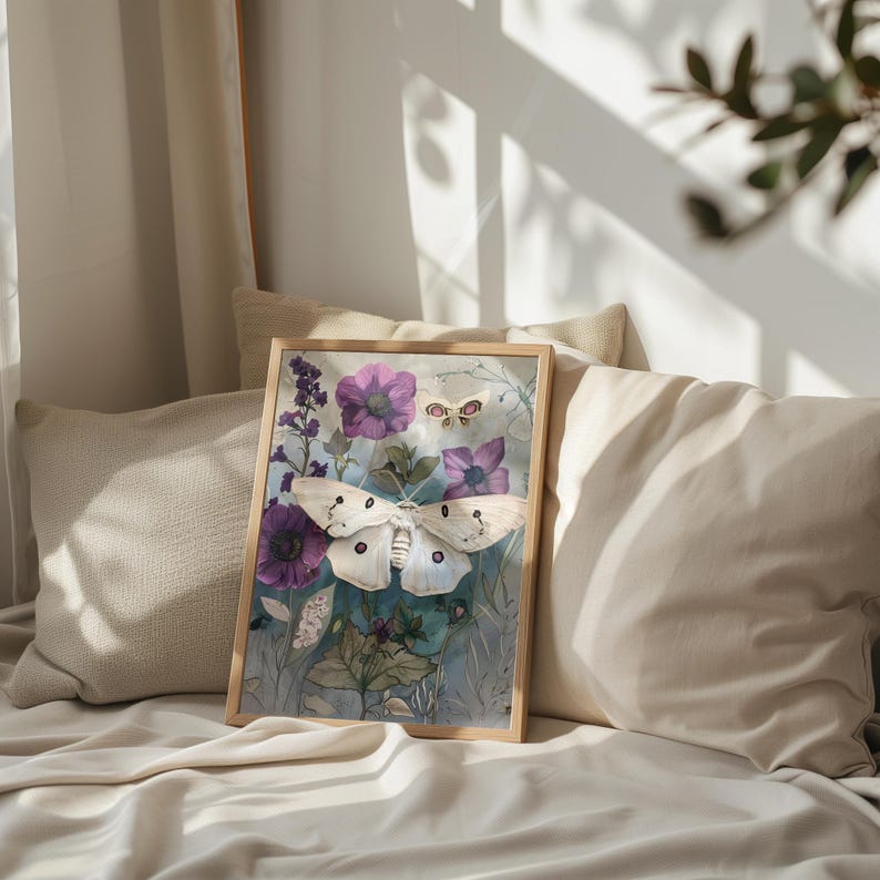 May include: A framed print of a white butterfly with purple flowers and green leaves on a blue background.