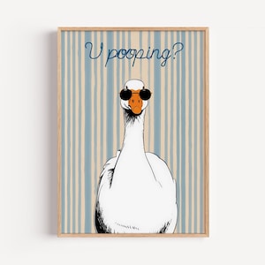 May include: A framed art print featuring a white goose wearing sunglasses. The goose is centered against a blue and beige striped background. The text "U pooping?" is written above the goose in a whimsical font.