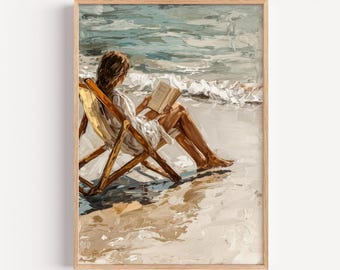 May include: A framed art print depicts a person reading a book while seated in a wooden beach chair. The artwork features a beach scene with ocean waves and a sandy shore, rendered in a painterly style with warm, neutral tones.