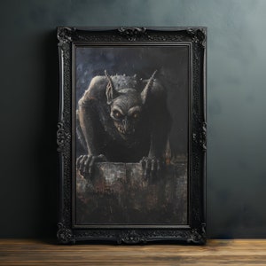 May include: A framed painting of a dark gray gargoyle with large ears, peering over a stone wall. The gargoyle is depicted in a realistic style with a menacing expression.