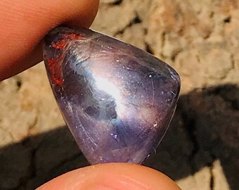 May include: A purple and blue gemstone with a pointed shape and a shiny, iridescent surface.