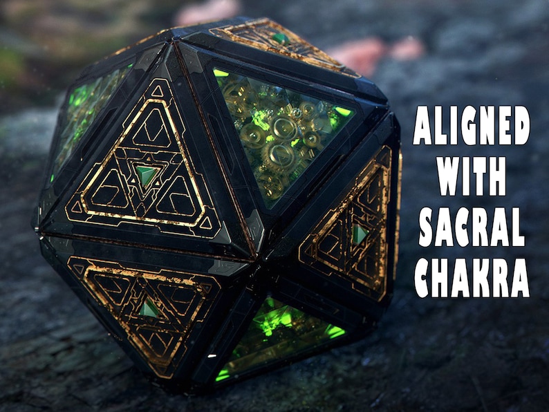 May include: A black and gold geometric crystal with green accents. The crystal is inscribed with the text "ALIGNED WITH SACRAL CHAKRA".