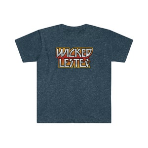 May include: A dark blue t-shirt with a graphic of the text "WICKED LES'TER" in a retro style with red, orange, and yellow colors.
