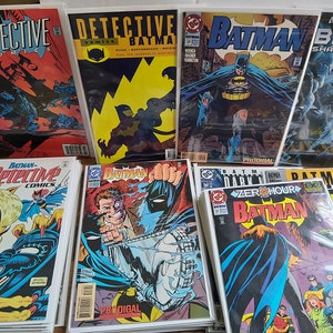 May include: A collection of comic books featuring Batman, Detective Comics, and Batman: Shadow of the Bat. The covers are a mix of blue, red, yellow, and black with various illustrations of Batman and other characters.