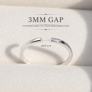 May include: A silver-toned open band ring featuring a 3mm gap. The text 3MM GAP and CUSTOMIZABLE TO YOUR PREFERRED SIZE is printed above the ring, with a dashed line indicating the 3mm gap measurement between the two ends of the metal band.