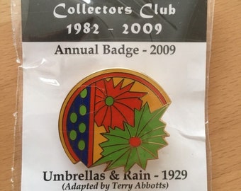 Clarice Cliff Collectors Club (CCCC) enamel badge from 2009. Umbrellas and Rain.