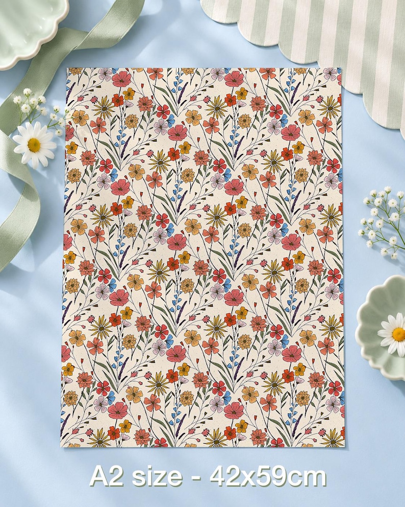 May include: A rectangular A2 size sheet measuring 42x59cm featuring a repeating pattern of wildflowers in shades of red, orange, yellow, and blue on a cream background, with thin green stems and leaves connecting the floral elements.