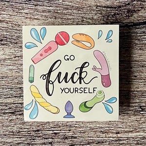 May include: Square sticker with a white background featuring various sex toys in pink, orange, yellow, green, and purple. The words "GO FUCK YOURSELF" are written in black script. Blue water droplet illustrations surround the toys.