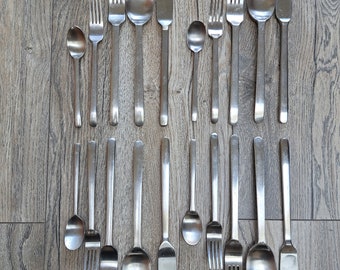May include: A collection of stainless steel cutlery arranged in two rows, consisting of various sizes of spoons, forks, and knives with smooth, plain handles. The set includes multiple dinner spoons, salad spoons, dinner forks, salad forks, and knives.
