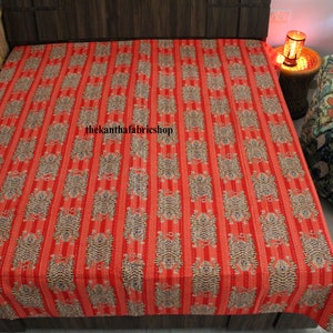 May include: Red and white striped kantha quilt with a repeating pattern of small, stylized animals. The quilt is made of cotton and has a hand-stitched look. The text "thekanthafabricshop" is visible in the center of the quilt.