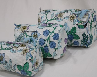 May include: Three white cotton makeup bags with a floral print featuring blue berries, green leaves, and light blue flowers. The largest bag has a blue bird on it. The text "Thekanthafabricshop" is visible on the middle bag.