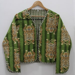 May include: Green quilted jacket with a striped lining and a tiger print. The jacket has a V-neck and button closure. The text "thekanthafabricshop" is visible on the jacket.