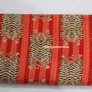 May include: Red and orange kantha quilt with a repeating pattern of black and brown tigers. The quilt has a striped background and the text "TheKanthaFabricShop" is visible in the center.