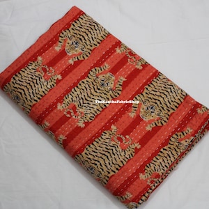 May include: Red and black striped fabric with a repeating pattern of tigers. The fabric is folded in half and has a subtle texture.