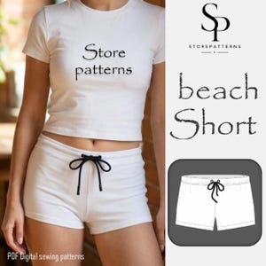 Peut inclure: Haut court blanc et short assorti avec cordon de serrage noir. Le t-shirt porte l'inscription "Store patterns". L'image comprend également le texte "beach Short" et un logo StorePatterns.