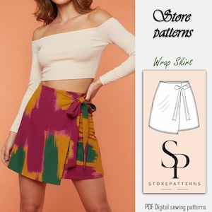 Può includere: Una donna indossa un top color crema con spalle scoperte e maniche lunghe e una gonna a portafoglio. La gonna presenta un design astratto colorato nei toni del bordeaux, verde e oro. La gonna è legata in vita con un fiocco di tessuto abbinato. L'immagine include il testo "Store patterns" e "Wrap Shirt".
