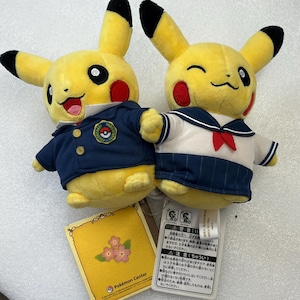 May include: A set of three ceramic mugs with a speckled, matte finish. The mugs are in shades of cream, light gray, and dark gray. Each mug has a simple, minimalist design and a rounded handle.