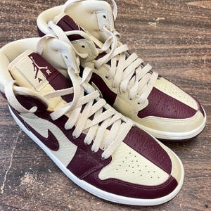 May include: A set of three ceramic mugs with a speckled, matte finish. The mugs are in shades of cream, light gray, and dark gray. Each mug has a simple, minimalist design, perfect for coffee or tea.