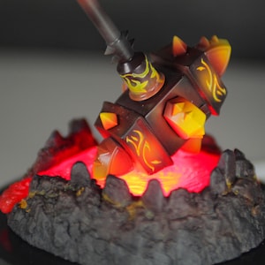 May include: A black and yellow hammer with a glowing red base. The hammer is made of plastic and has a detailed design.