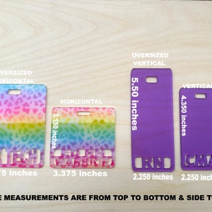 May include: Four different sizes of name badges with various designs. The badges are made of plastic and have a rainbow, leopard print, and solid purple design. The badges are 2.25 inches wide and 4.35 inches tall. The badges are labelled with the text "RN", "CMA", "Warrior", and "Rx Tech".