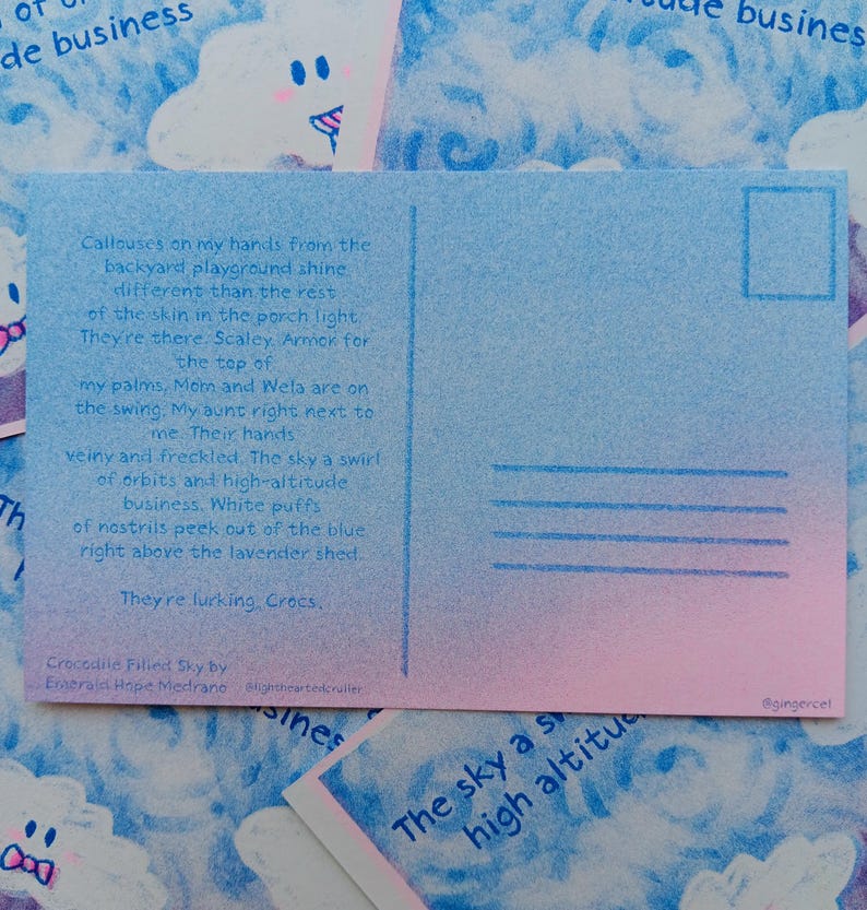 May include: A postcard with a blue and pink gradient. The left side has handwritten text, the right side has lines for an address. The text includes "Crocodile Filled Sky" and the artist's name. The postcard is a unique piece of art.