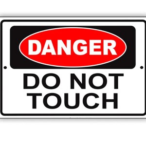 May include: A white rectangular sign with black and red text. The sign reads "DANGER DO NOT TOUCH".