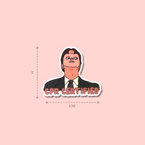May include: A sticker featuring a cartoon illustration of a man in a suit with the text "CPR CERTIFIED". The sticker is approximately 2 inches tall and 2.38 inches wide, with a pink background.