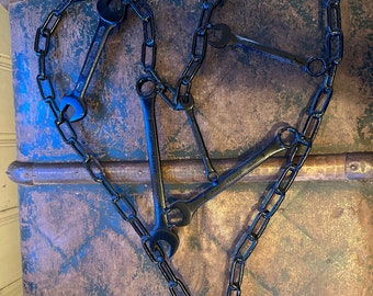 Welded chain heart with wrenches wall decor