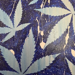 May include: Abstract painting featuring a blue background with white splatter paint and a pattern of light blue marijuana leaves.