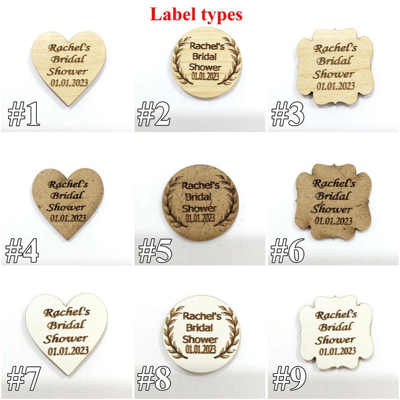 May include: Nine wooden labels in heart, circular, and scalloped shapes, labeled #1 through #9. Each features the engraved text Rachel's Bridal Shower 01.01.2023. The labels vary in wood tone from light to dark, with some circular designs featuring a leaf border.