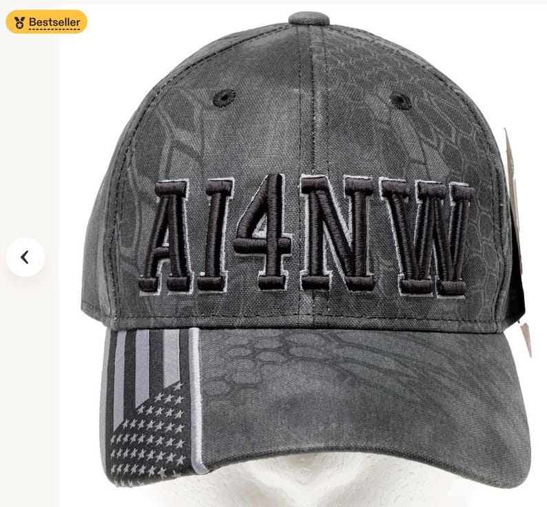 May include: A gray baseball cap with the text "AI4NW" embroidered in black. The cap features a camouflage pattern and a design with the American flag on the brim. A "Bestseller" badge is in the top left corner.