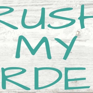 May include: Teal blue text on a white wood background reads "Rush My Order".