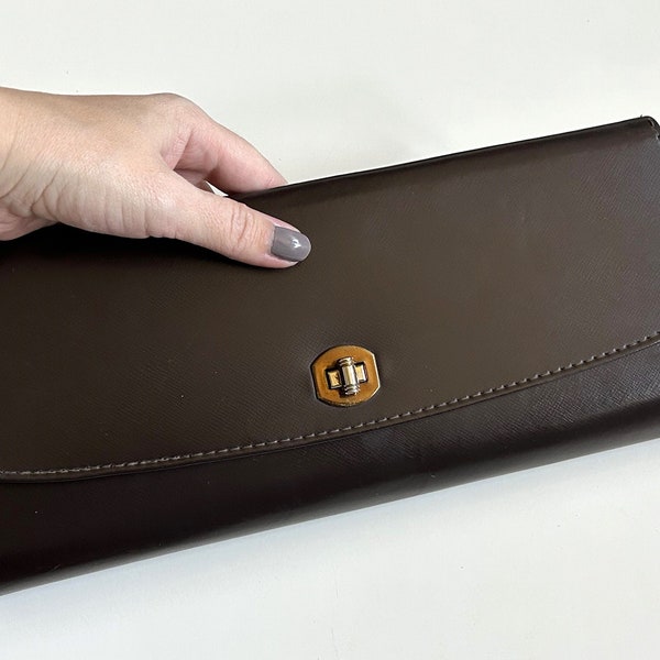 Long sleek 1960s chocolate brown faux leather clutch, turn lock closure, vintage purse