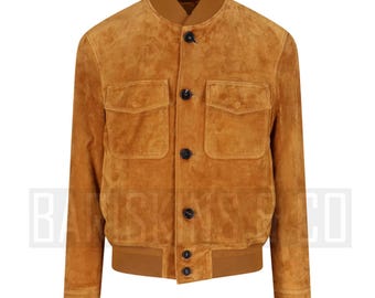May include: A tan suede bomber jacket with a ribbed collar, cuffs, and hem. The jacket features two front pockets with flaps and four black buttons down the front. The jacket is a classic style.